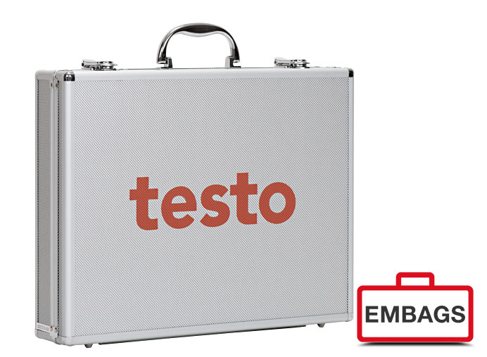 A silver hard-shell briefcase with a black handle and the word testo in large orange letters on the front. Ideal for B2B use, with a red and white EMBAGS logo and a case symbol in the bottom right-hand corner.