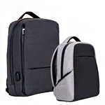 Two backpacks are shown side by side on a white background. One backpack is dark gray with a top handle and a front zipper pocket, while the other is light gray and black with a simpler design.